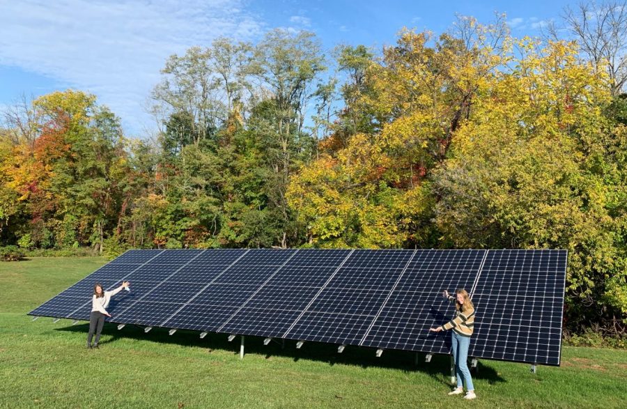 Lulu Hart and Olivia Selby embrace the new solar panels on RHS campus.