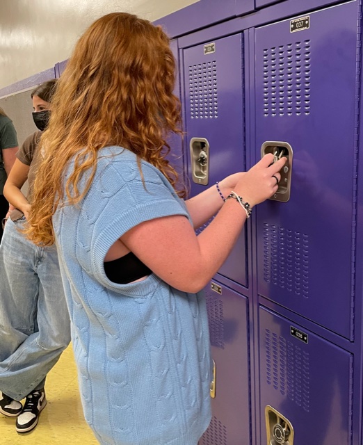 Joey Dull, class of 2022, accesses her locker to obtain her laptop. Over the summer, the RHS staff placed the MacBooks in lockers for us to receive when we arrive at the school. However, some students--especially those new to our district--- had some initial trouble actually getting their tech up and running. 