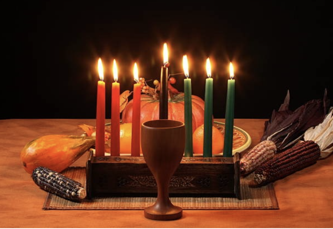 A traditional  centerpiece includes a candelabra with seven candles representing the seven principles of Kwanzaa.